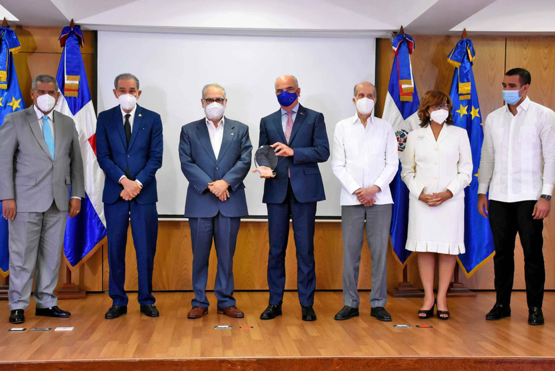 Miguel Ceara Hatton, ministro de Economía. Planificación y Desarrollo, entrega la placa de reconocimiento al embajador Gianluca Grippa, jefe de la Delegación de la Unión Europea en República Dominicana, le acompañan, Darío Castillo Lugo, ministro de Administración Pública; Franklin García Fermín, ministro de Educación Superior, Ciencia y Tecnología; Max Puig, vicepresidente ejecutivo del Consejo Nacional para el Cambio Climático y Mecanismo de Desarrollo Limpio; Olaya Dotel, viceministra de Cooperación Internacional del Ministerio de Economía y Ordenadora Nacional de los Fondos Europeos para el Desarrollo y José Julio Gómez, viceministro de Política Exterior Bilateral del Ministerio de Relaciones Exteriores.